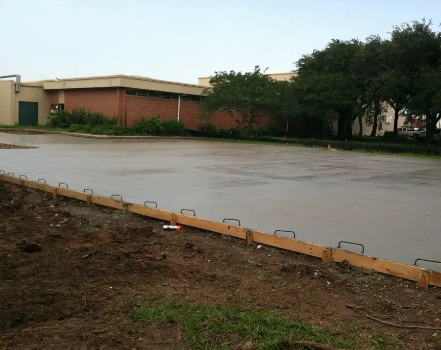 A finished concrete slab, wide shot, forms still in place