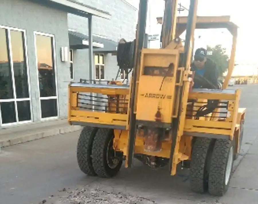 A forklift moving equipment across a job site