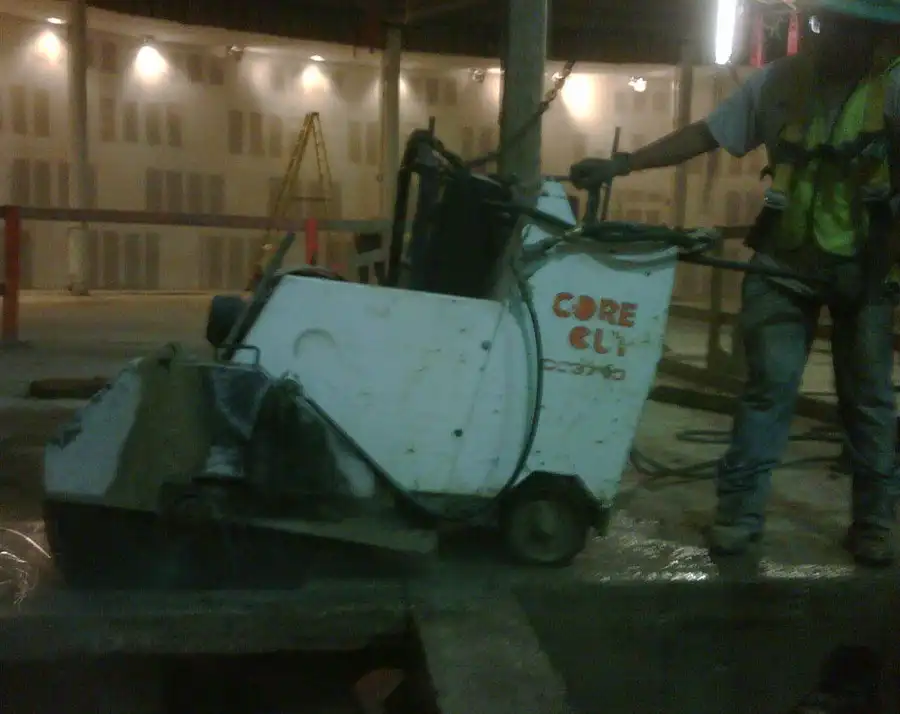 A walk-behind slab saw working an indoor floor